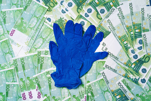 Medical gloves on a background of Euro banknotes - Foto, Imagen