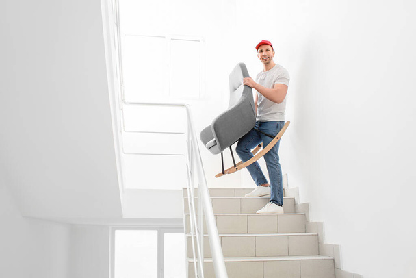 Loader carrying furniture in the stairway - Fotó, kép