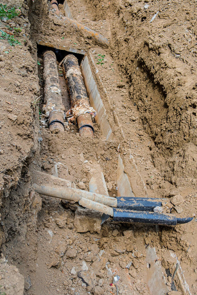 Old leaky pipes in the pit. Preparation for pipe replacement. - Photo, Image