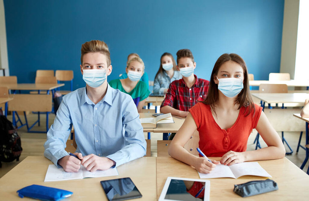 group of students in masks at school lesson - Photo, image