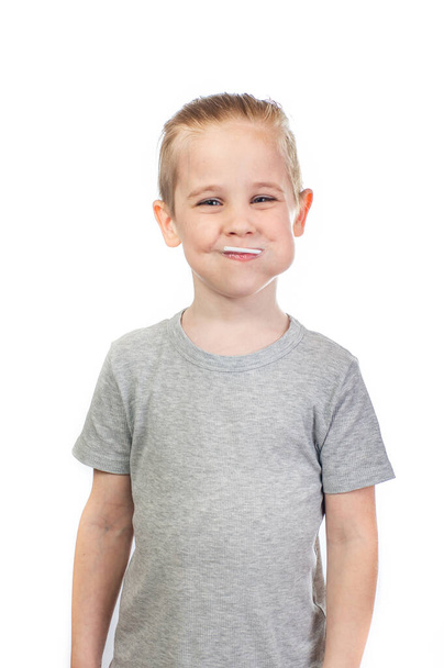 Young smiling caucasian boy with lollipop in mouth isolated on white background - Foto, immagini