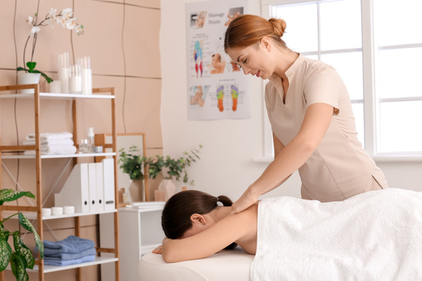 Massage therapist working with patient in medical center - Foto, Imagem