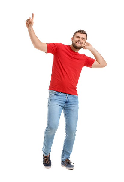 Handsome young man dancing against white background - Foto, afbeelding