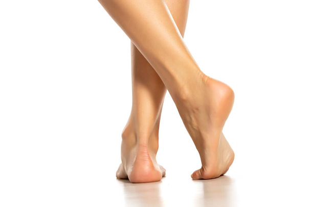 beautiful female foot on white background - 写真・画像