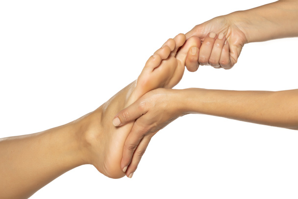 massaggio ai piedi femminile su sfondo bianco
 - Foto, immagini
