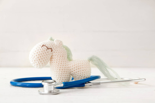 Toy with stethoscope on white background - Foto, Imagem
