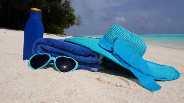 Hat with towel, sunglasses and lotion. Exotic vacation in Maldives, South Asia.  - Footage, Video