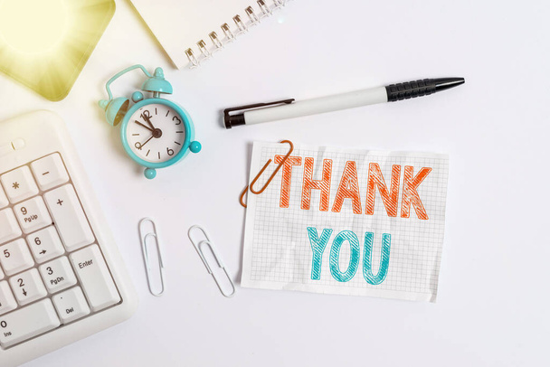 Conceptual hand writing showing Thank You. Business photo text a polite expression used when acknowledging a gift or service Flat lay above computer mobile phone clock pencil and note paper. - Fotografie, Obrázek