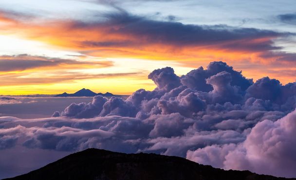 Amazing cloudscape with mt Rinjani at horizon View from mt Agung crater rim at sunrise Bali - Foto, imagen