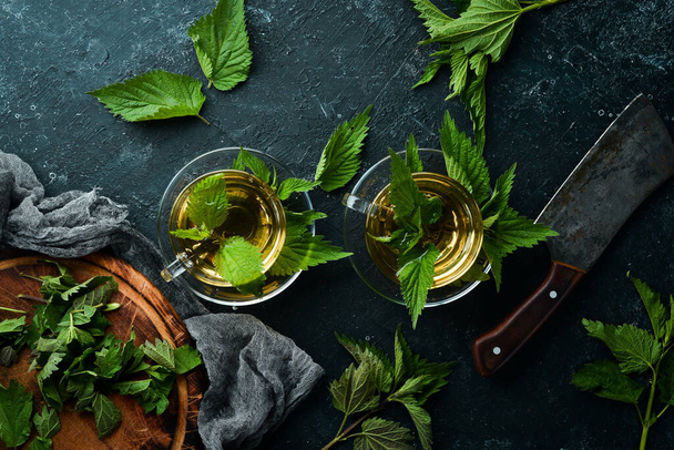 Nettle tea in cups. Immunostimulating herbal drinks. Top view. Free space for your text. - Foto, Imagen