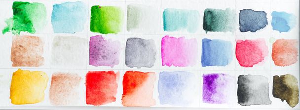 Watercolor paints multicolored pattern on a white paper as a picture background. - Photo, Image