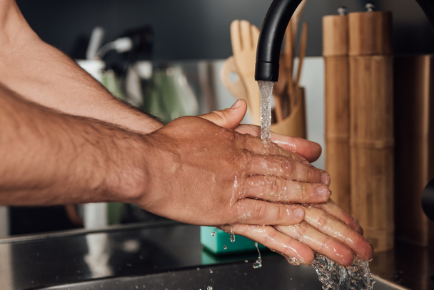 close up of man washing hands at home - 写真・画像