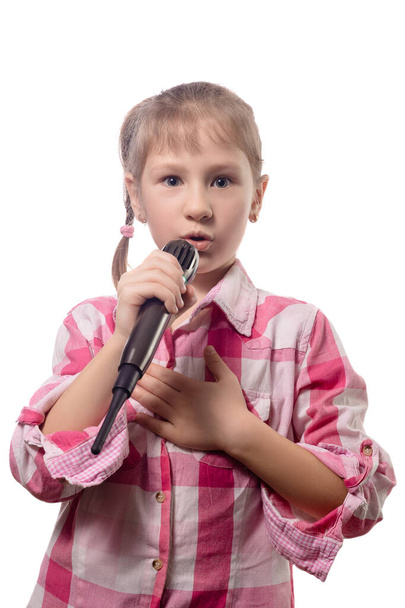 Little cute girl singing into a microphone isolated on a white background - Foto, immagini