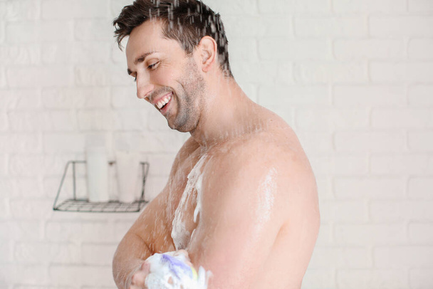 Beau homme prenant une douche à la maison
 - Photo, image