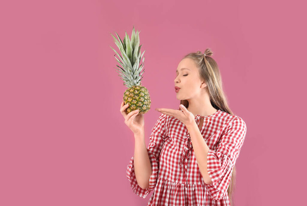 Young woman with pineapple on color background. Diet concept - Foto, Imagem