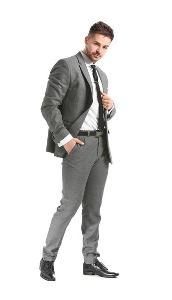 Handsome young man in elegant suit on white background - Foto, Bild