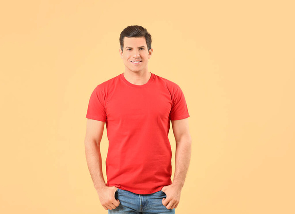 Man in stylish t-shirt on color background - 写真・画像