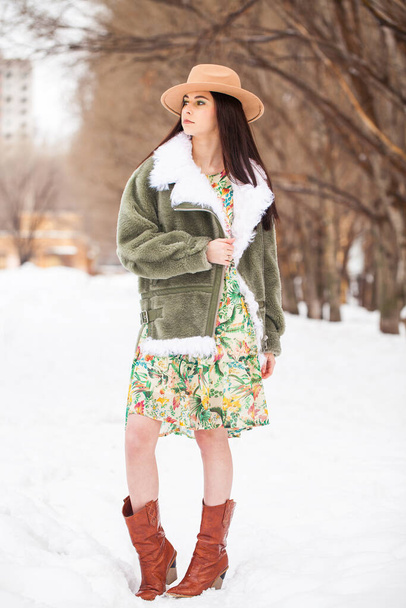 Portrait of a young beautiful teenager girl in winter park - Fotó, kép