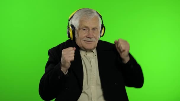 Starszy biały dziadek tańczy, świętuje, słucha muzyki. Klucz chromowy - Materiał filmowy, wideo