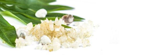 Spa banner cosmetic treatment concept. Sea resort salt, yellow salt and green leaves on a white background. Copyspase flatlay - Photo, Image
