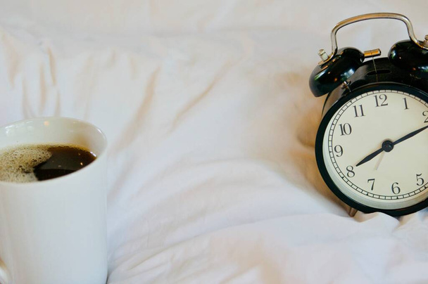 waking up in the morning in the bed with a cup of coffee, simple, home, space in the frame - 写真・画像