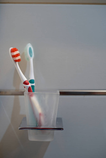 red and white and green and white toothbrushes on based - Valokuva, kuva