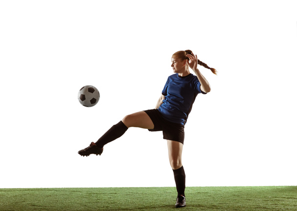 Female soccer, football player kicking ball, training in action and motion with bright emotions isolated on white background - Photo, Image