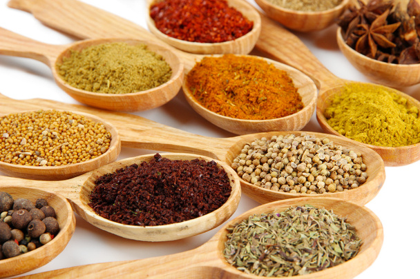 Assortment of spices in wooden spoons - Photo, Image