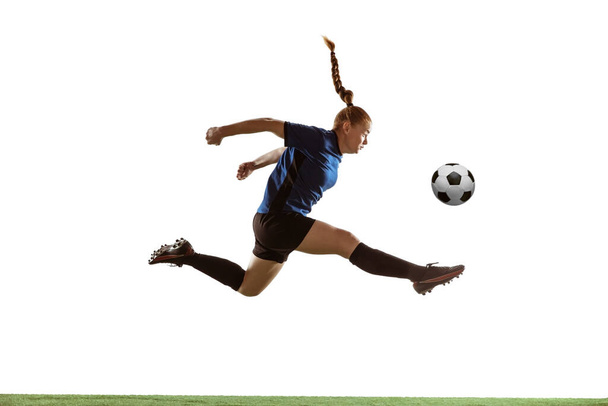 Female soccer, football player kicking ball, training in action and motion with bright emotions isolated on white background - Fotoğraf, Görsel