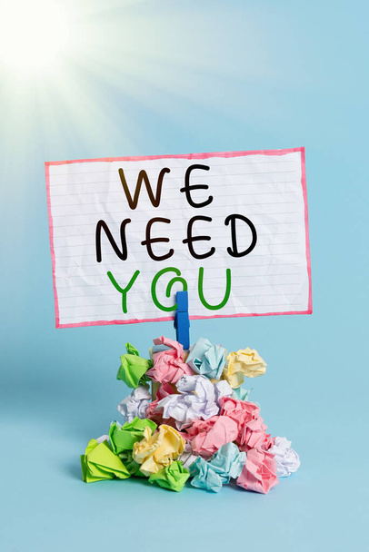 Conceptual hand writing showing We Need You. Business photo showcasing asking someone to work together for certain job or target Reminder pile colored crumpled paper clothespin wooden space. - Photo, Image