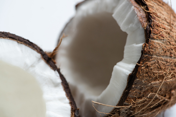 close up view of tasty coconut halves on white background - Fotoğraf, Görsel
