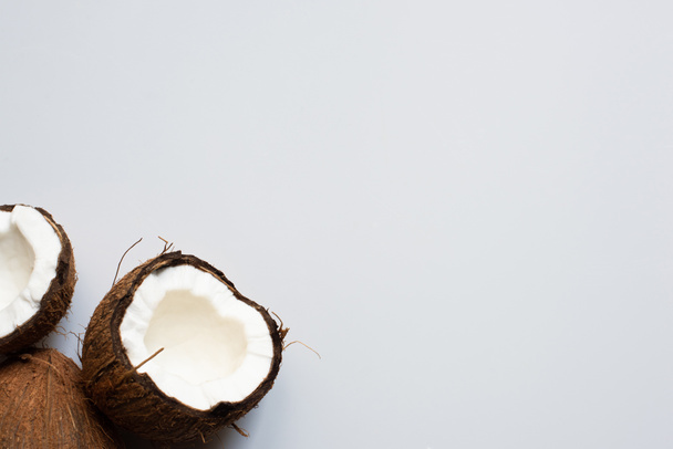 top view of fresh tasty whole coconut and halves on white background - Foto, imagen