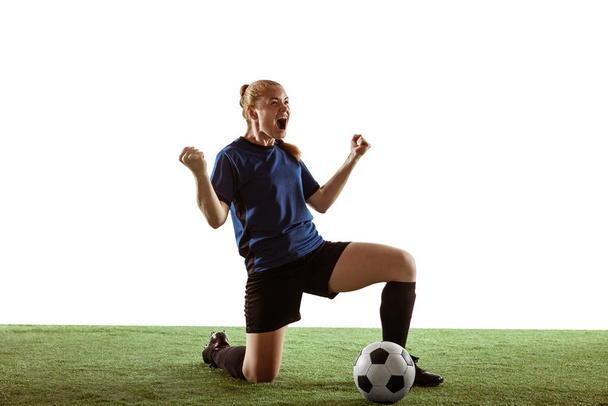 Female soccer, football player celebrating goal winning with bright expressive emotions isolated on white background - Valokuva, kuva