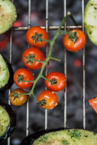 Kiraz domatesli şube açık ateşte ızgarada pişiyor. - Fotoğraf, Görsel