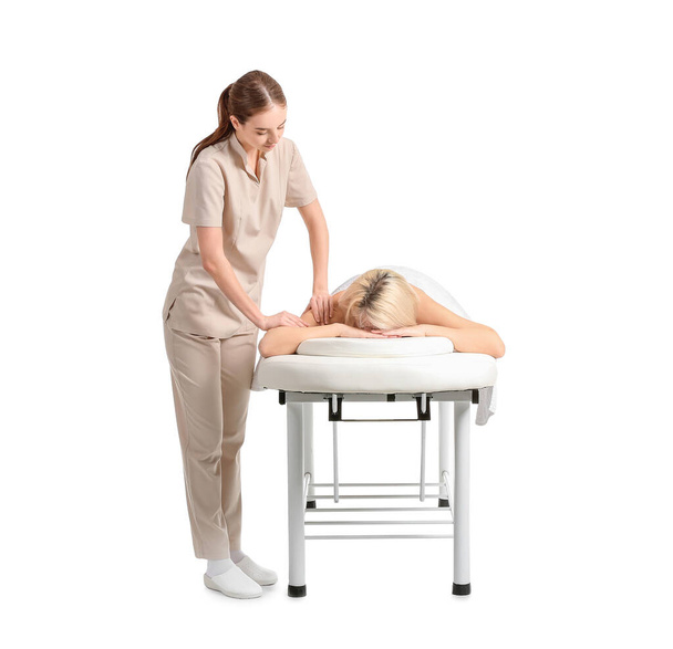 Massage therapist working with female patient on white background - Photo, Image