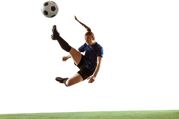 Female soccer, football player kicking ball, training in action and motion with bright emotions isolated on white background - Фото, изображение