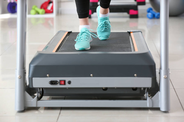 Sporty young woman training on treadmill in gym - Photo, Image