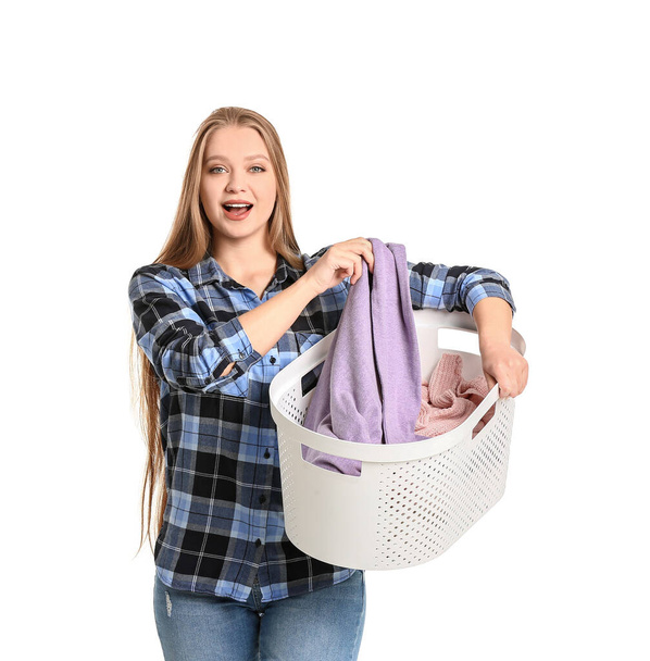 Young woman with laundry on white background - 写真・画像