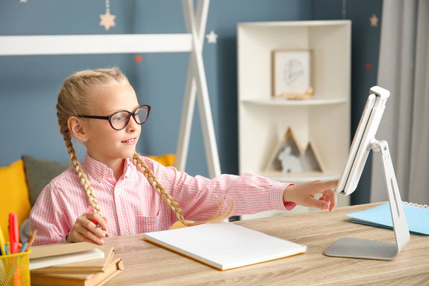 Cute little girl studying at home. Concept of online education - Photo, Image
