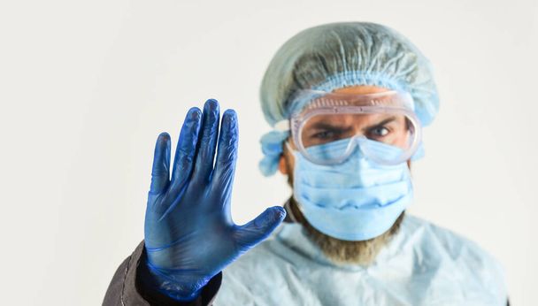 man doctor in protective gloves and glasses. wear respirator mask. nurse in uniform. caution. lock down. stop coronavirus. stay at home restrictions. Preventive measures for infectious diseases - Photo, image