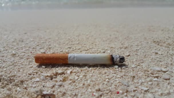 Cigarette laying on sandy beach. Summer trip to Maldives  - Footage, Video
