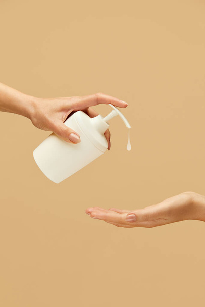 Hygiene. Hands Using Liquid Soap Against Beige Background. Daily Routine With Antibacterial Products For Virus Prevention And Staying Healthy.  - Фото, изображение