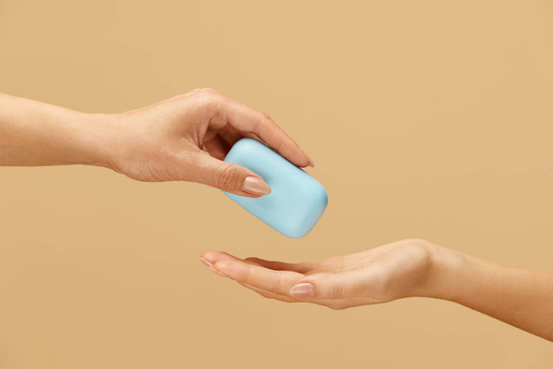 Hygiene. Soap Bar In Caucasian Female Hand On Beige Background. Daily Personal Hygiene Routine As Virus And Bacterial Infection Prevention. Washing Hands For Saving Life.  - 写真・画像