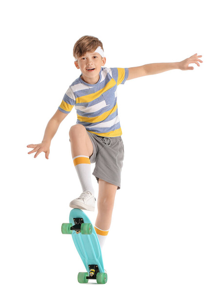 Sporty little boy with skateboard on white background - Photo, Image