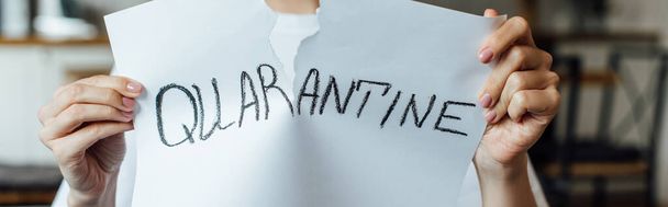 Cropped view of woman tearing card with quarantine lettering, panoramic crop - Foto, afbeelding
