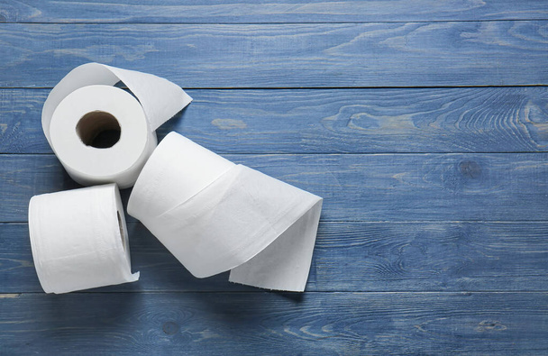Rolls of toilet paper on wooden background - Photo, Image