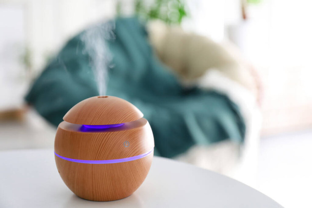Aroma oil diffuser on table in room - Photo, Image