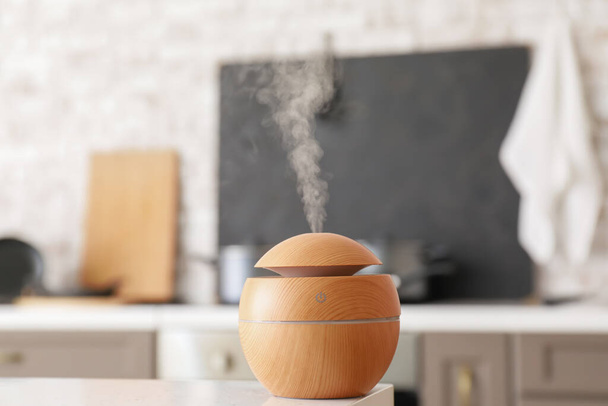 Aroma oil diffuser on table in kitchen - Photo, Image