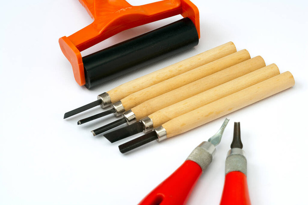 Art and crafts - linocut tools on white paper - Photo, Image