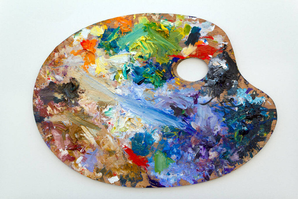 Vibrant multi-coloured artists oil or acrylic paints palette on textured white paper - Photo, Image
